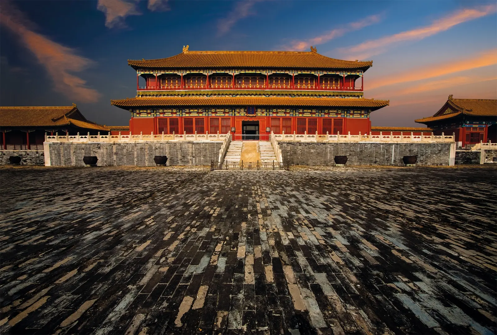 A palace building in the Forbidden City with a paved courtyard in the foreground.