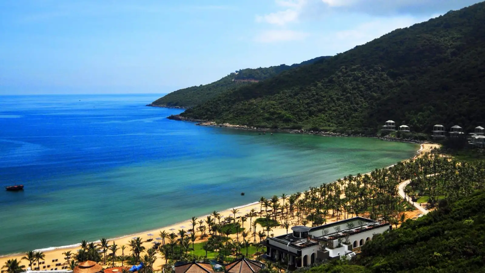 Picturesque cove with a sandy beach and lush green hills in Da Nang.