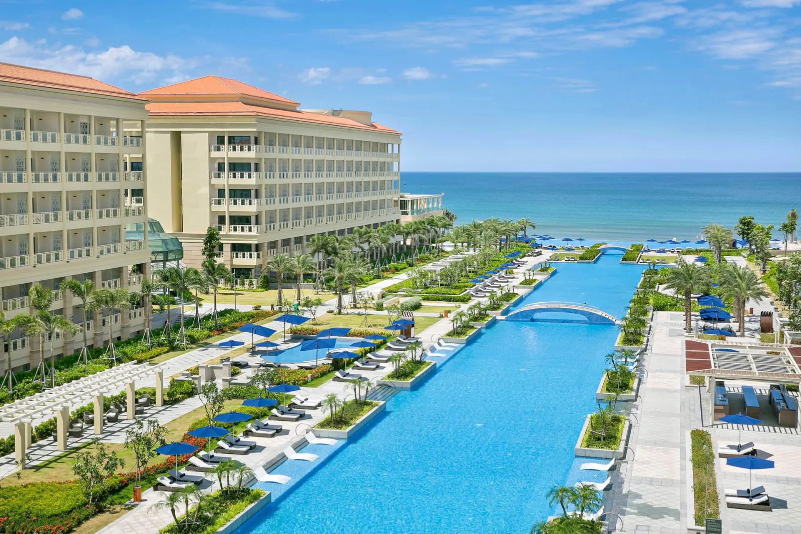 Outdoor pool and resort buildings of Sheraton Grand Danang on the oceanfront.