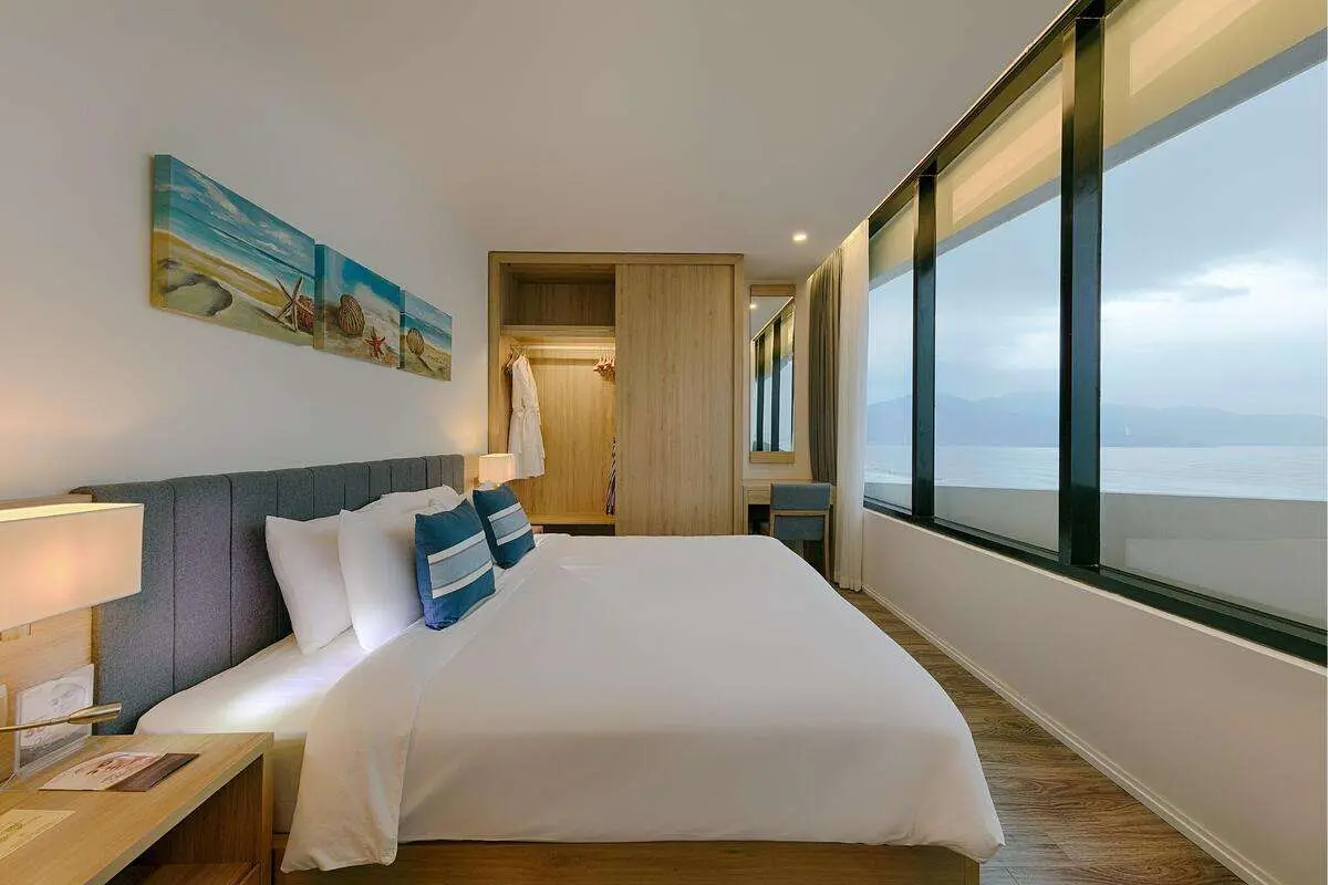 Cozy hotel room with a large bed and panoramic sea views.