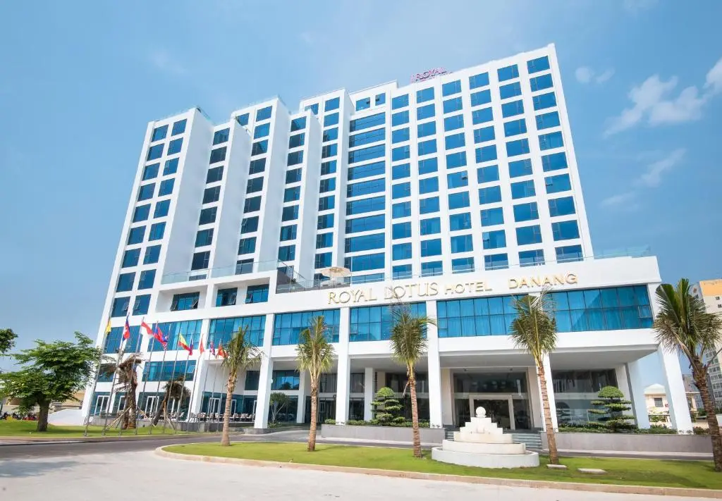 Exterior facade of the modern Royal Lotus Hotel Danang on a sunny day.