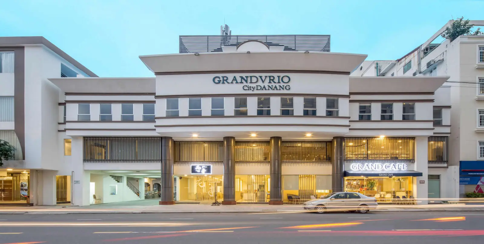 Exterior facade of Grandvrio City Danang illuminated at twilight
