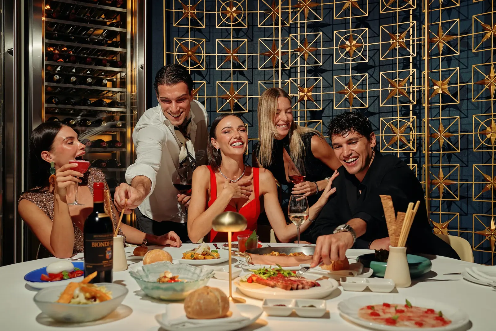 Guests enjoying dinner at a restaurant in FIVE Palm Jumeirah hotel.