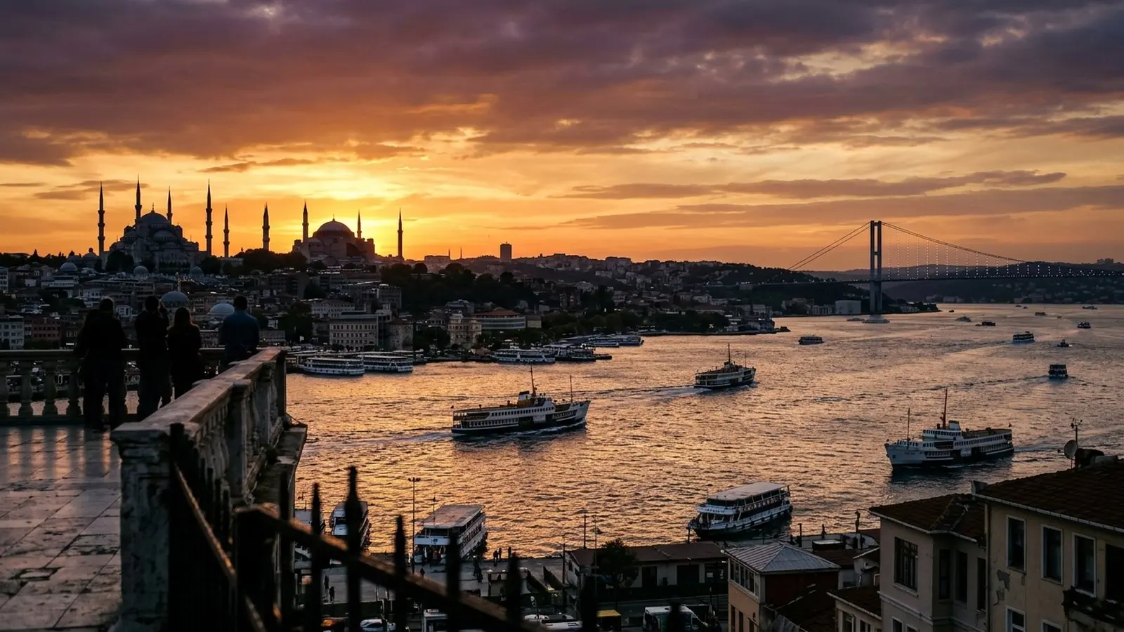 Panoramic view of the Bosphorus and Istanbul mosque silhouettes against a sunset sky